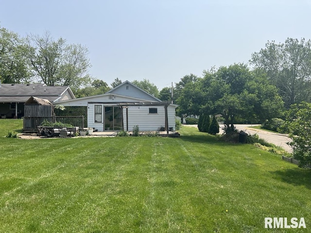 836 S Johnson St, Macomb, IL 61455 - back of property featuring a yard and a patio