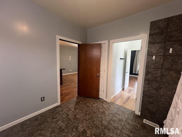 836 S Johnson St, Macomb, IL 61455 - unfurnished bedroom featuring baseboards