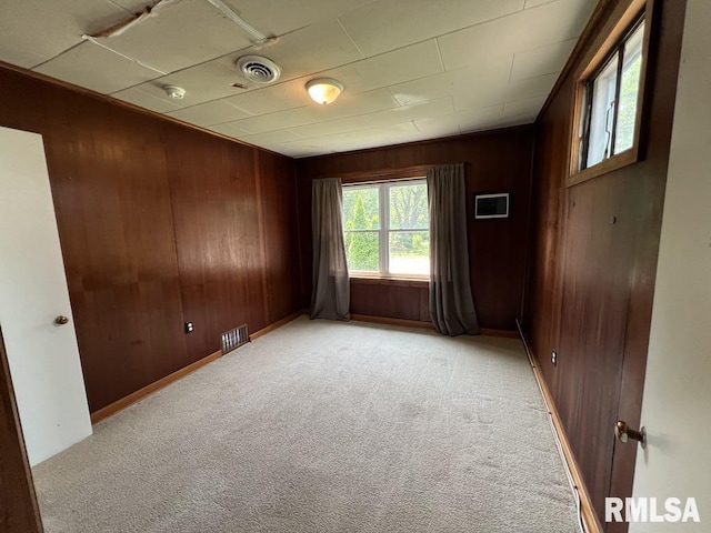 836 S Johnson St, Macomb, IL 61455 - unfurnished room featuring wood walls, light carpet, and a smoke detector