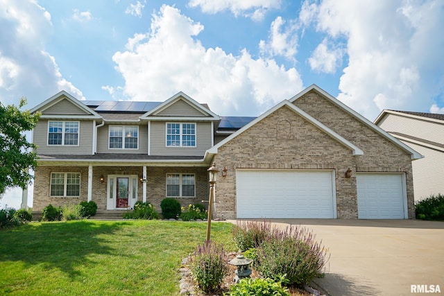521 S French Dr, Dunlap, IL 61525 - view of front of house featuring concrete driveway, an attached garage, a front lawn, brick siding, and roof mounted solar panels
