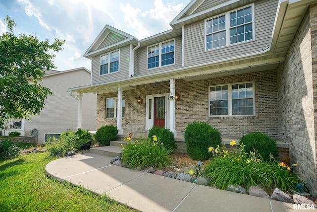 521 S French Dr, Dunlap, IL 61525 - view of front facade featuring brick siding and a porch