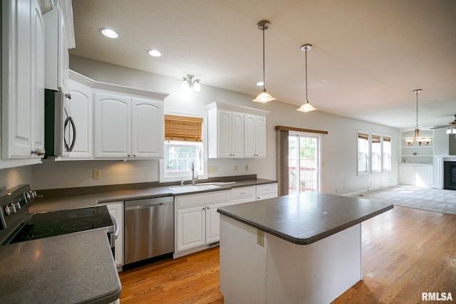 521 S French Dr, Dunlap, IL 61525 - kitchen with stainless steel appliances, dark countertops, open floor plan, white cabinets, and recessed lighting