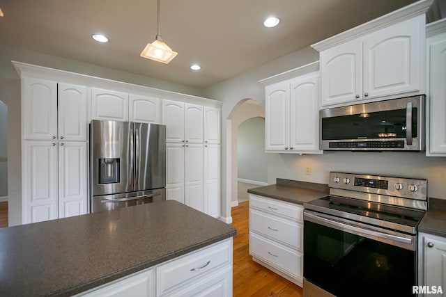 521 S French Dr, Dunlap, IL 61525 - kitchen featuring stainless steel appliances, dark countertops, arched walkways, light wood finished floors, and recessed lighting