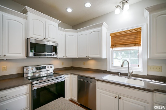 521 S French Dr, Dunlap, IL 61525 - kitchen with appliances with stainless steel finishes, dark countertops, recessed lighting, and white cabinets