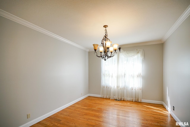 521 S French Dr, Dunlap, IL 61525 - unfurnished room with a chandelier, ornamental molding, and light wood-type flooring