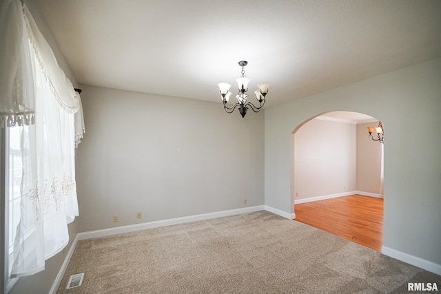 521 S French Dr, Dunlap, IL 61525 - empty room with a chandelier, carpet, and arched walkways