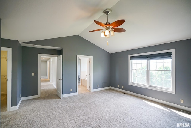 521 S French Dr, Dunlap, IL 61525 - unfurnished bedroom with lofted ceiling, carpet floors, a walk in closet, ensuite bath, and ceiling fan