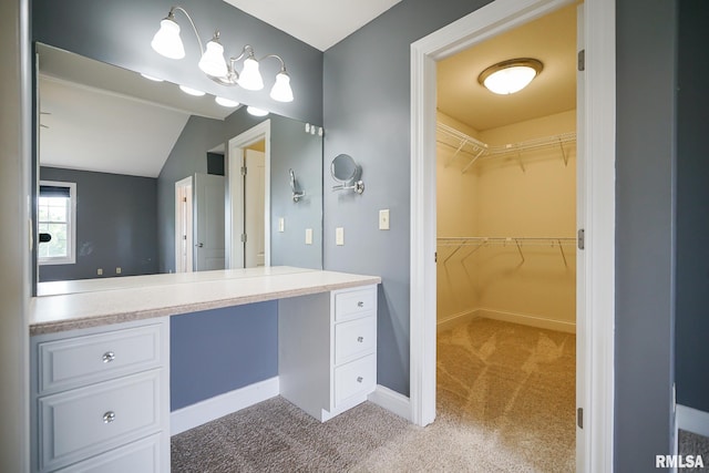 521 S French Dr, Dunlap, IL 61525 - bathroom featuring vanity, vaulted ceiling, and a walk in closet