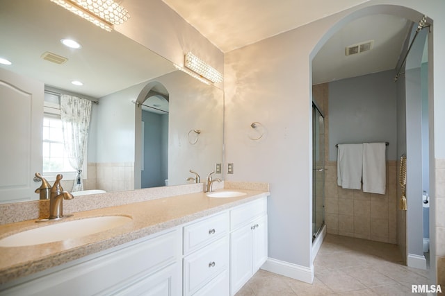 521 S French Dr, Dunlap, IL 61525 - bathroom featuring tile patterned floors, tile walls, double vanity, a stall shower, and a tub