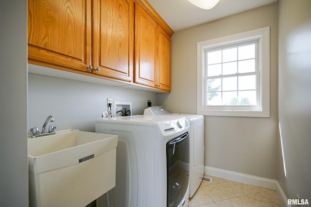 521 S French Dr, Dunlap, IL 61525 - laundry area with cabinet space, washing machine and clothes dryer, and light tile patterned floors