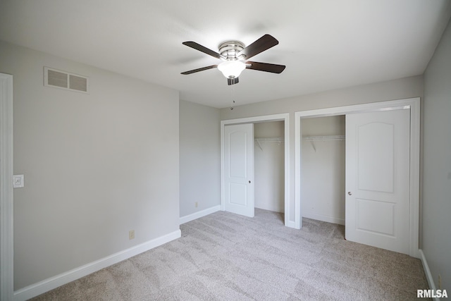 521 S French Dr, Dunlap, IL 61525 - unfurnished bedroom featuring two closets, carpet flooring, and a ceiling fan
