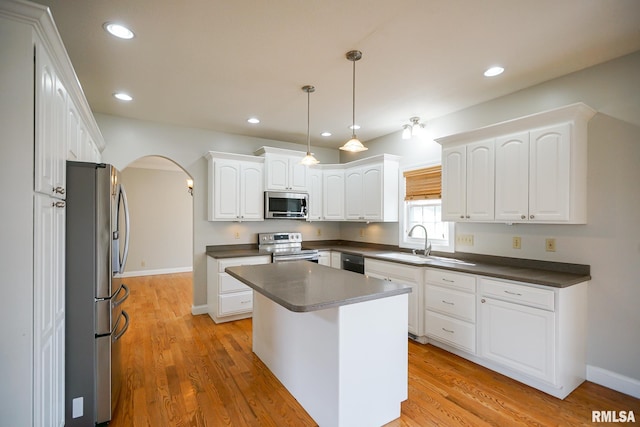 521 S French Dr, Dunlap, IL 61525 - kitchen with stainless steel appliances, dark countertops, arched walkways, white cabinetry, and recessed lighting