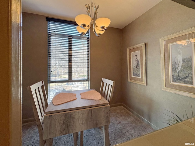 4444 N Knoxville Ave Unit 301, Peoria, IL 61614 - carpeted dining area featuring a chandelier and baseboards