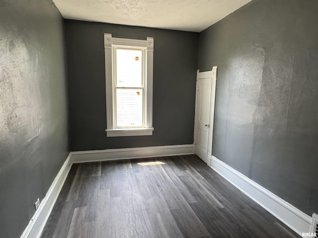 305 E Republic St, Peoria, IL 61603 - unfurnished room featuring dark wood finished floors, baseboards, and a textured ceiling