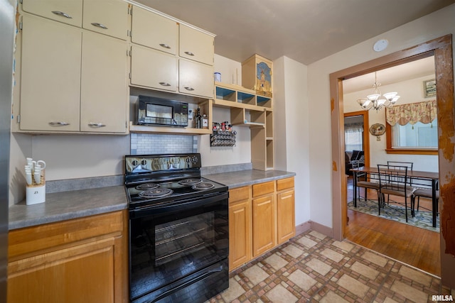 602 W Adams St, Abingdon, IL 61410 - kitchen with black appliances, a chandelier, open shelves, and baseboards