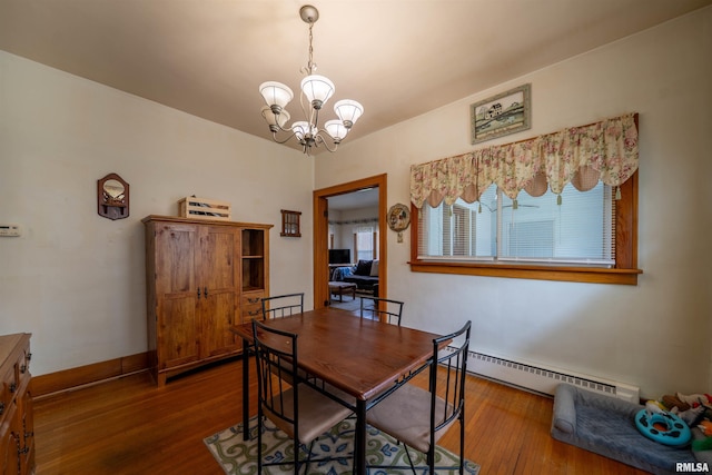 602 W Adams St, Abingdon, IL 61410 - dining area with a baseboard radiator, wood finished floors, and a chandelier