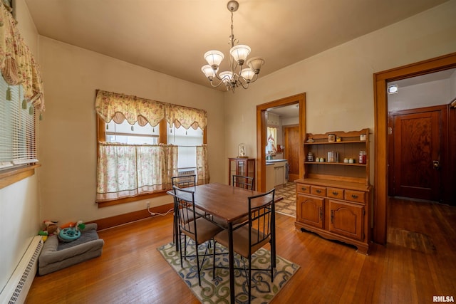 602 W Adams St, Abingdon, IL 61410 - dining area with a baseboard radiator, a chandelier, and hardwood / wood-style floors