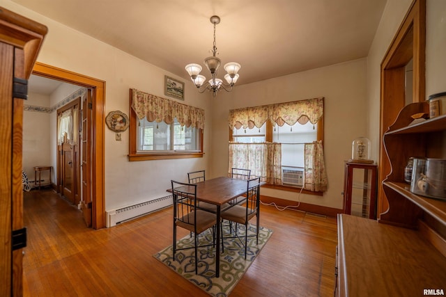 602 W Adams St, Abingdon, IL 61410 - dining room featuring a chandelier, a baseboard heating unit, wood finished floors, and baseboards