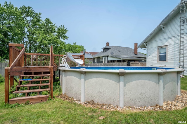 602 W Adams St, Abingdon, IL 61410 - view of swimming pool featuring a water slide, stairway, and a deck