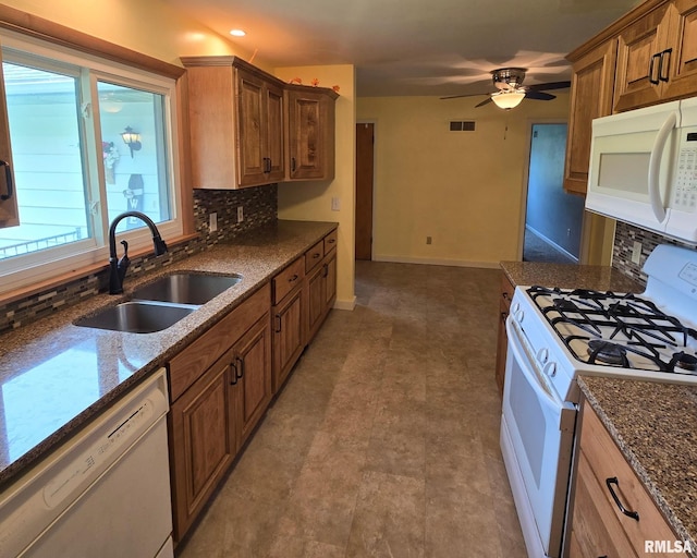 4928 W Farmington Rd, Peoria, IL 61604 - kitchen featuring white appliances, a sink, decorative backsplash, ceiling fan, and dark stone countertops