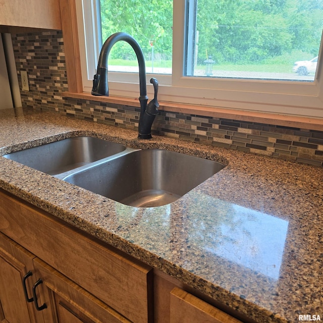 4928 W Farmington Rd, Peoria, IL 61604 - kitchen view of decorative backsplash, a sink, brown cabinets, and dark stone countertops