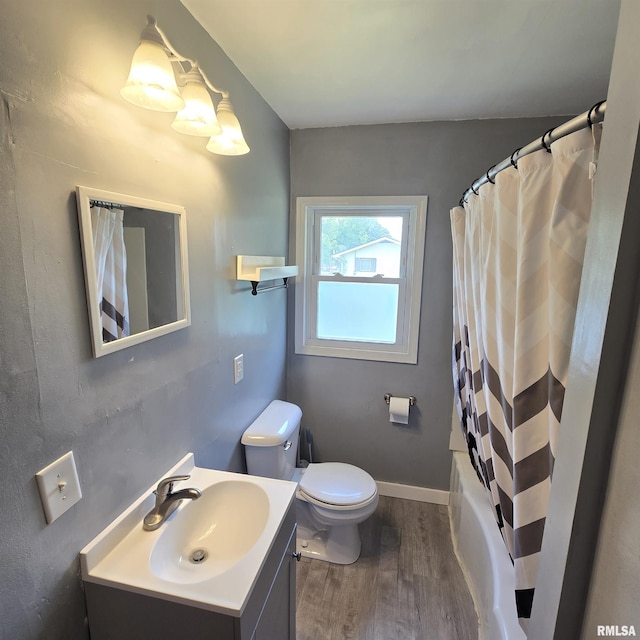 4928 W Farmington Rd, Peoria, IL 61604 - bathroom featuring vanity, wood finished floors, toilet, and shower / bath combo