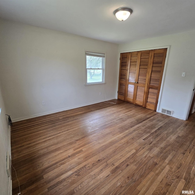 4928 W Farmington Rd, Peoria, IL 61604 - unfurnished bedroom featuring wood finished floors, a closet, and baseboards