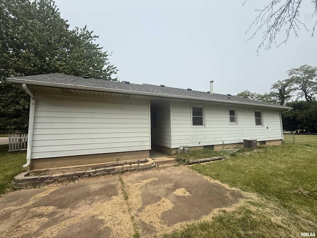 4928 W Farmington Rd, Peoria, IL 61604 - rear view of house with a yard, central AC unit, and roof with shingles