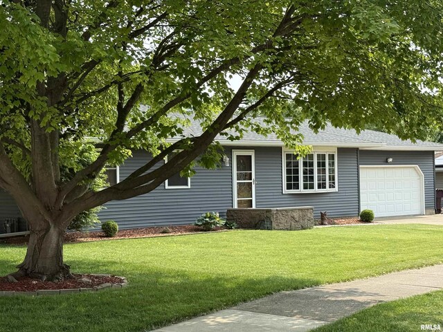 2123 Highwood Ave, Pekin, IL 61554 - view of front of home with a garage, a front lawn, driveway, and roof with shingles