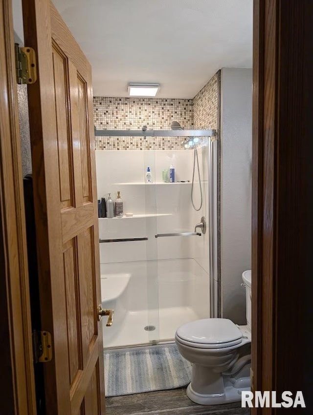 2123 Highwood Ave, Pekin, IL 61554 - bathroom with a stall shower, toilet, and wood finished floors