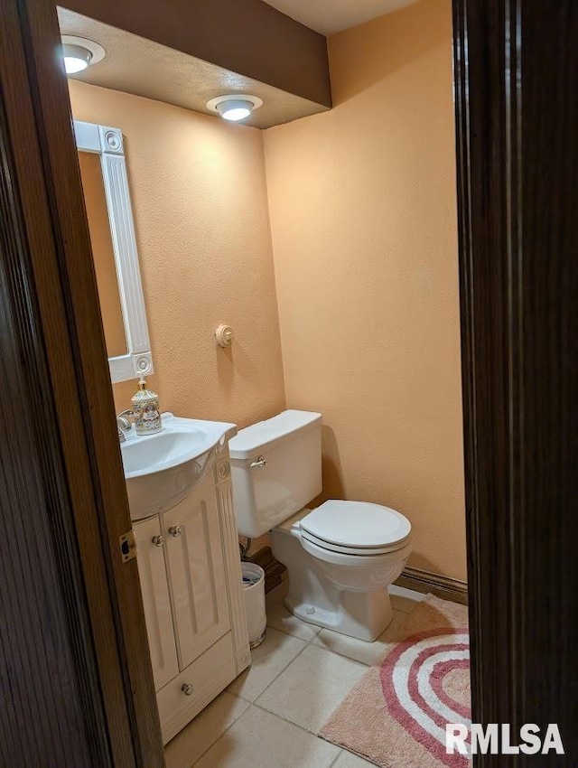 2123 Highwood Ave, Pekin, IL 61554 - half bathroom with vanity, toilet, and tile patterned flooring