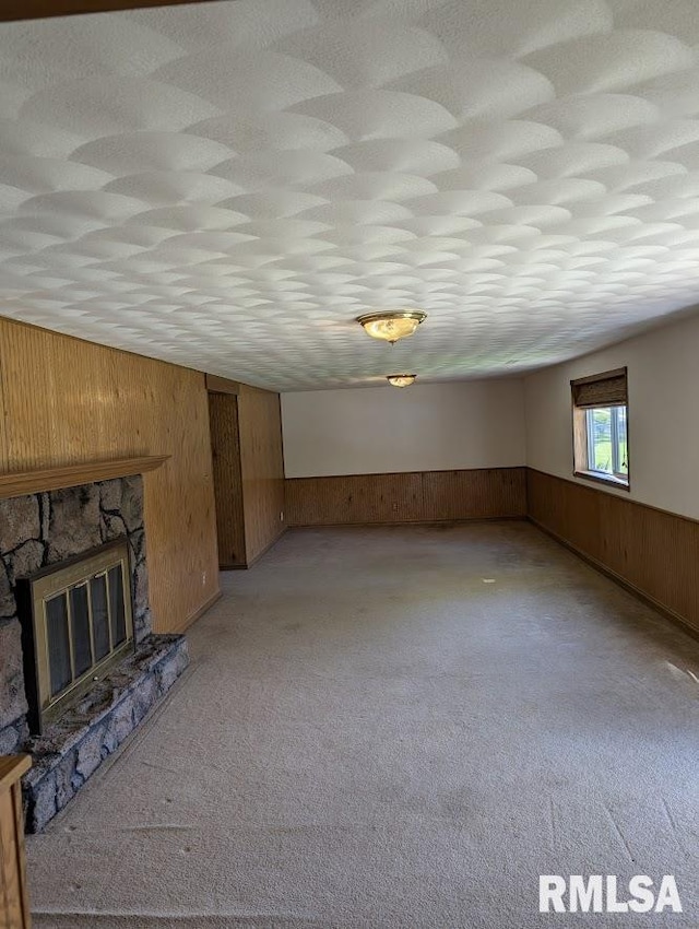 2123 Highwood Ave, Pekin, IL 61554 - unfurnished living room featuring wooden walls, a wainscoted wall, light colored carpet, and a fireplace