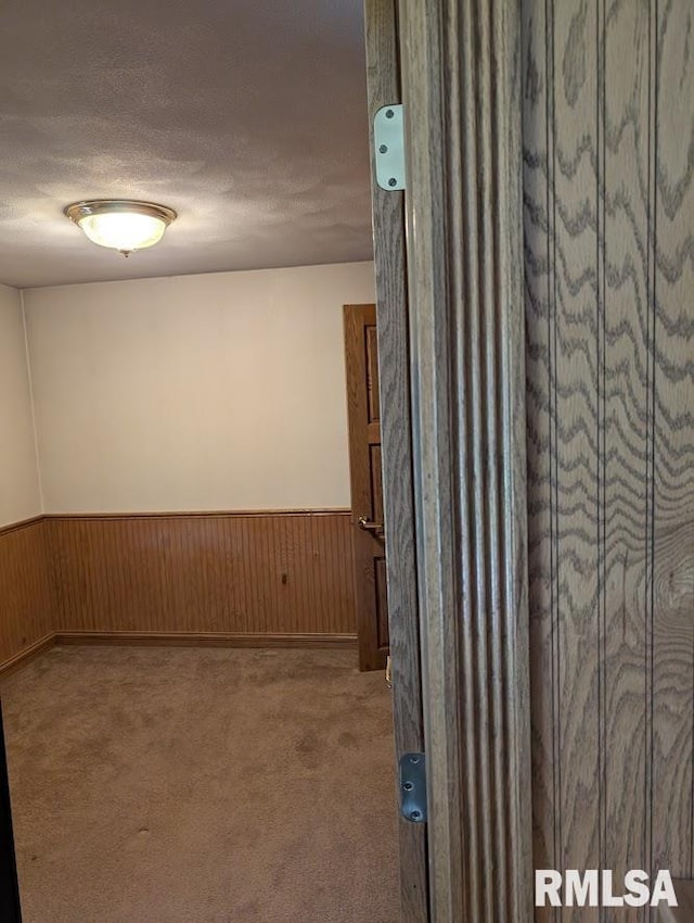 2123 Highwood Ave, Pekin, IL 61554 - corridor with a wainscoted wall, carpet floors, a textured ceiling, and wood walls