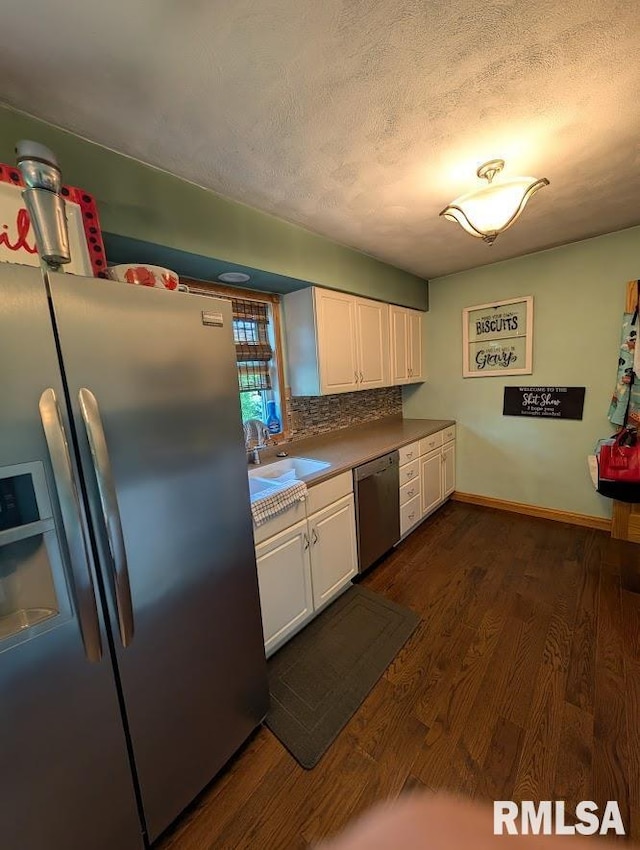 2123 Highwood Ave, Pekin, IL 61554 - kitchen featuring appliances with stainless steel finishes, a sink, white cabinetry, dark wood finished floors, and backsplash