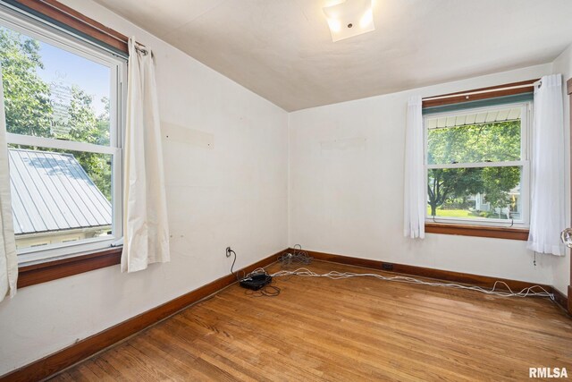 1111 S 4th St, Pekin, IL 61554 - spare room with wood finished floors, baseboards, and vaulted ceiling