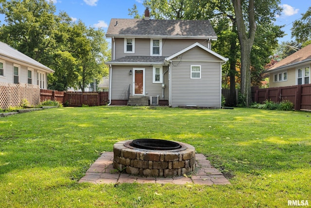 1111 S 4th St, Pekin, IL 61554 - back of property featuring entry steps, an outdoor fire pit, a chimney, and a shingled roof