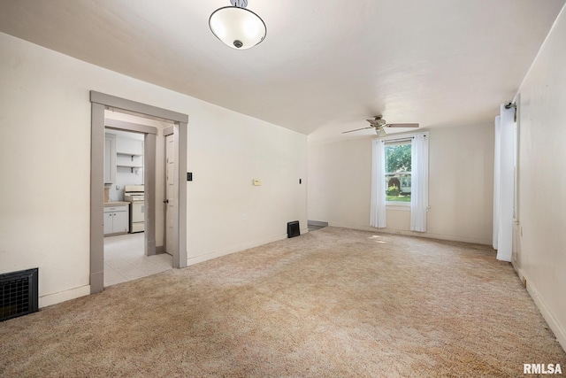 1111 S 4th St, Pekin, IL 61554 - unfurnished living room featuring a ceiling fan, light colored carpet, and baseboards