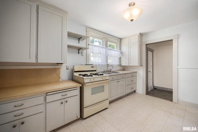 1111 S 4th St, Pekin, IL 61554 - kitchen featuring white gas stove, light countertops, a sink, and open shelves