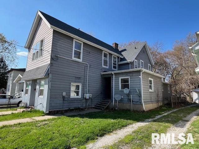 907 E Republic St, Peoria, IL 61603 - rear view of property featuring a yard and a chimney