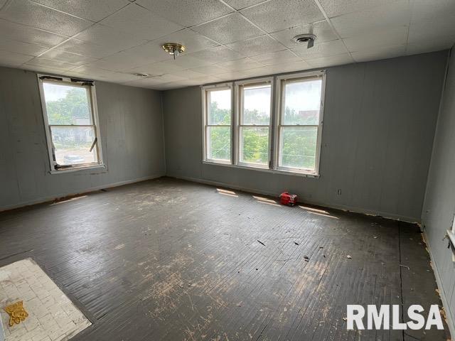 907 E Republic St, Peoria, IL 61603 - empty room with hardwood / wood-style flooring, healthy amount of natural light, and a paneled ceiling