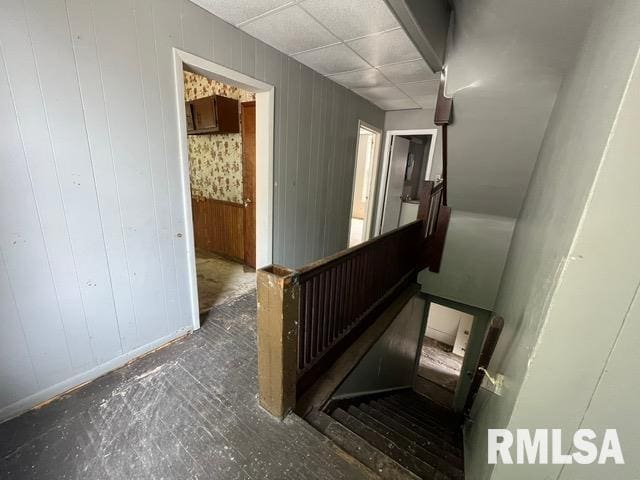 907 E Republic St, Peoria, IL 61603 - stairs featuring baseboards and wood walls