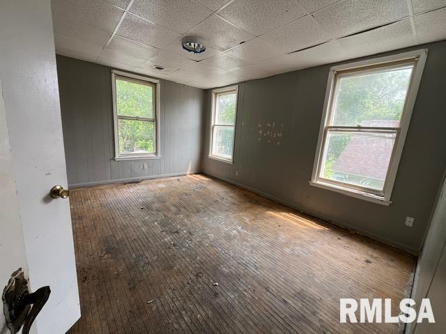 907 E Republic St, Peoria, IL 61603 - spare room featuring a paneled ceiling and hardwood / wood-style floors