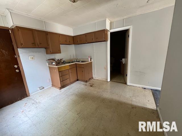 907 E Republic St, Peoria, IL 61603 - kitchen with light flooring, brown cabinetry, and light countertops