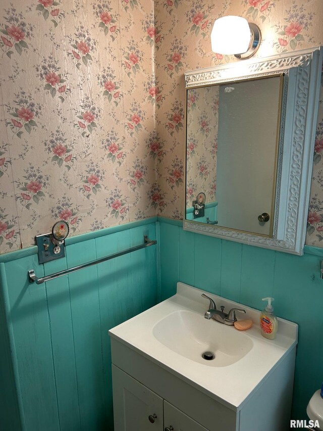 1407 Lincoln St, Pekin, IL 61554 - bathroom with wallpapered walls, vanity, and a wainscoted wall