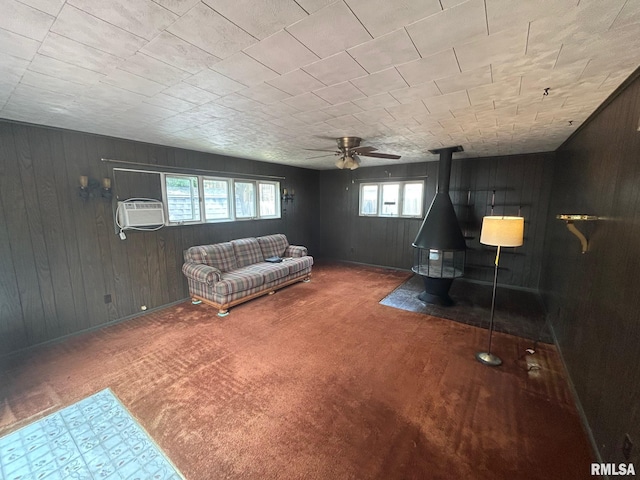 1407 Lincoln St, Pekin, IL 61554 - carpeted living area with wooden walls, a ceiling fan, a wood stove, and an AC wall unit