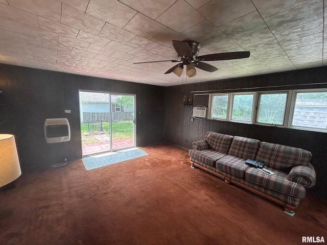 1407 Lincoln St, Pekin, IL 61554 - carpeted living room featuring wood walls, a ceiling fan, heating unit, and an AC wall unit