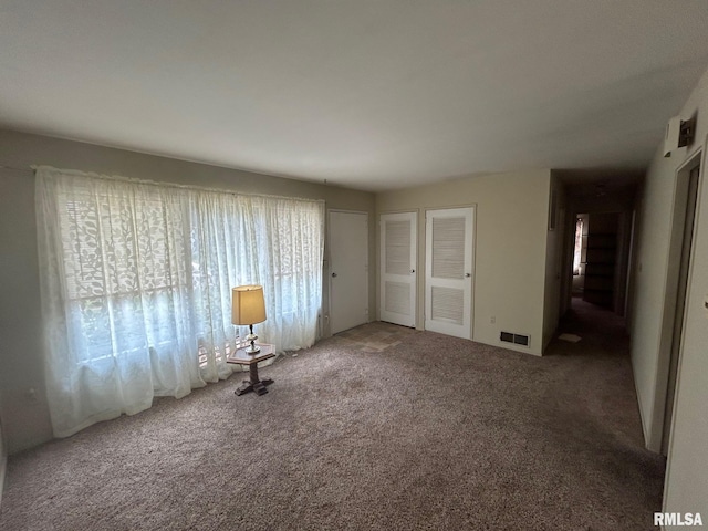 1407 Lincoln St, Pekin, IL 61554 - unfurnished bedroom with multiple windows and carpet floors