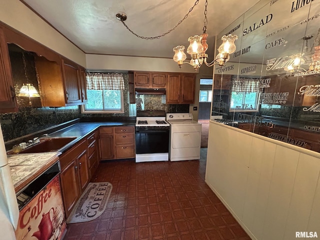1407 Lincoln St, Pekin, IL 61554 - kitchen featuring white range with gas stovetop, washer / dryer, under cabinet range hood, decorative backsplash, and dishwasher