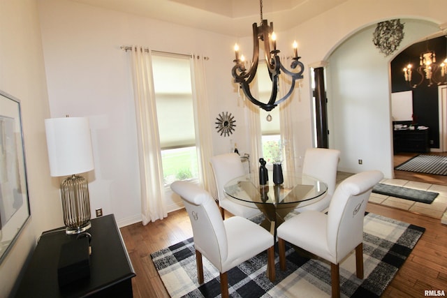 1964 Chestnut Ln, Washington, IL 61571 - dining area featuring a chandelier, arched walkways, and wood finished floors
