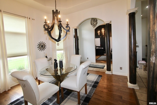 1964 Chestnut Ln, Washington, IL 61571 - dining area featuring a chandelier, wood finished floors, arched walkways, and decorative columns